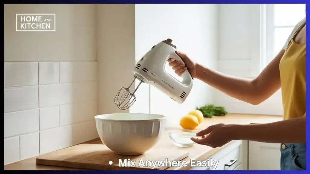 Person using a compact cordless hand mixer in a small kitchen