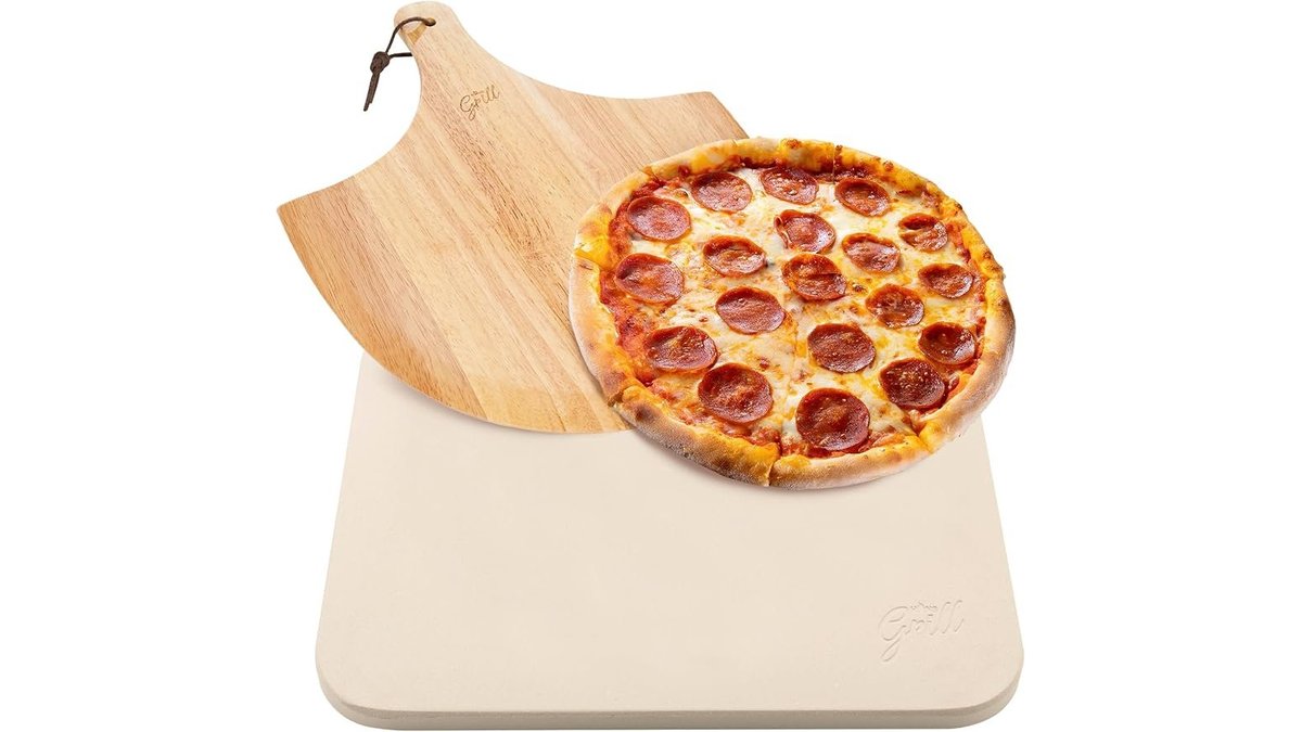 Cordierite pizza stone inside a modern oven with natural lighting.