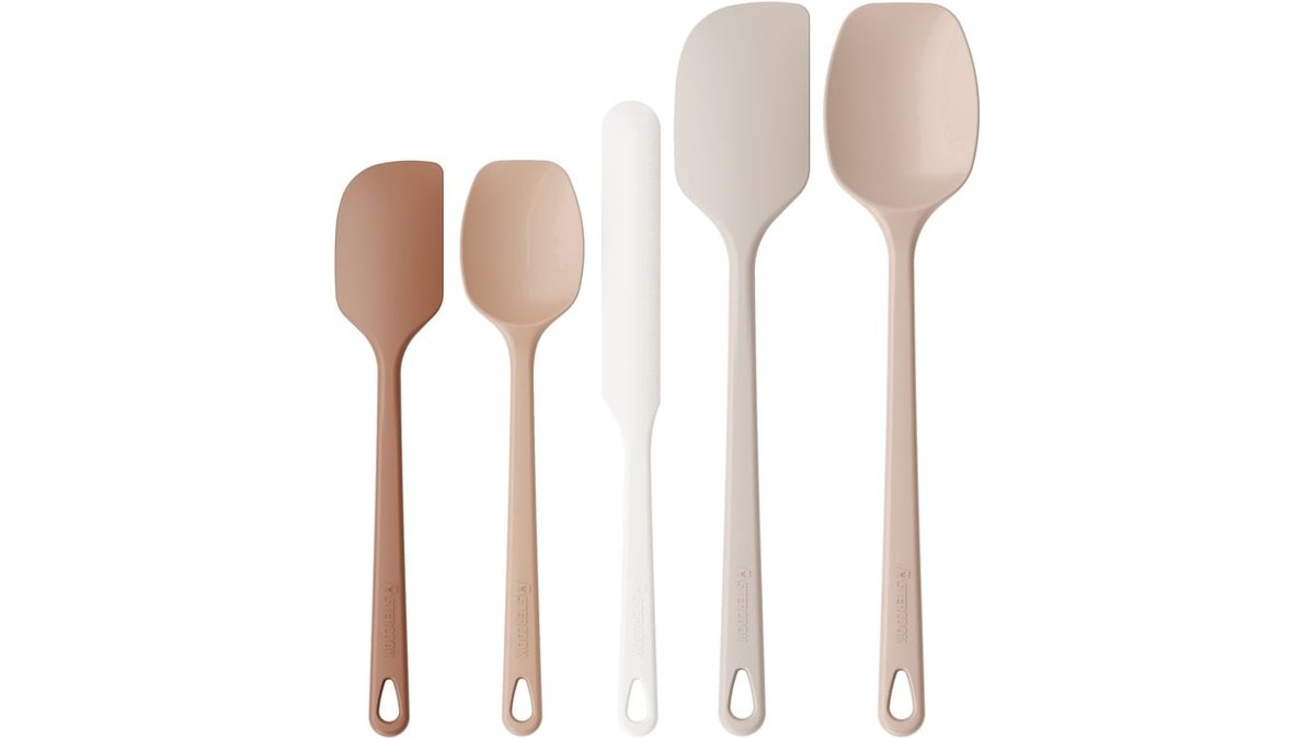 Heat resistant silicone spatula set resting on an oak kitchen counter.