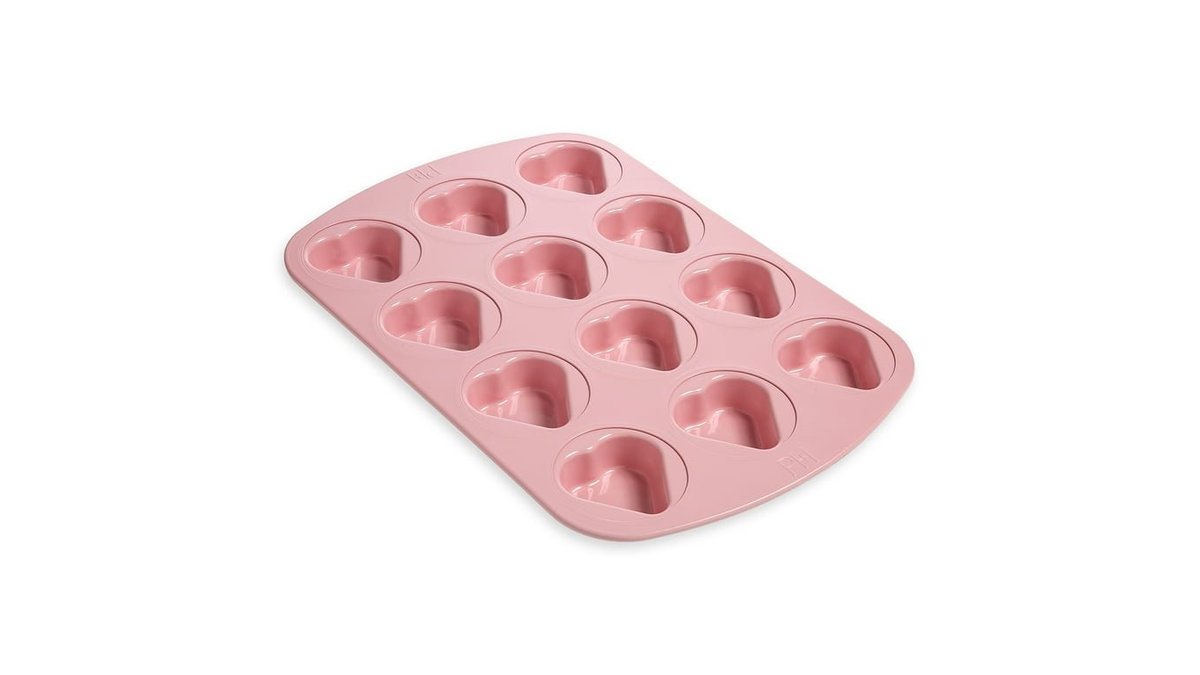A heavy duty muffin pan 12 cup filled with fresh golden blueberry muffins.