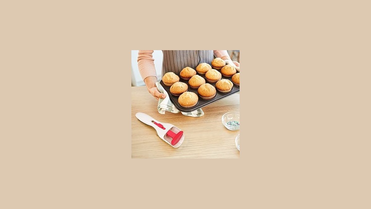 A modern kitchen tool precisely pours cupcake batter into a muffin tin tray.