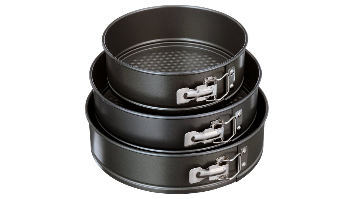 A professional nonstick springform cake pan set displayed on a marble kitchen counter.
