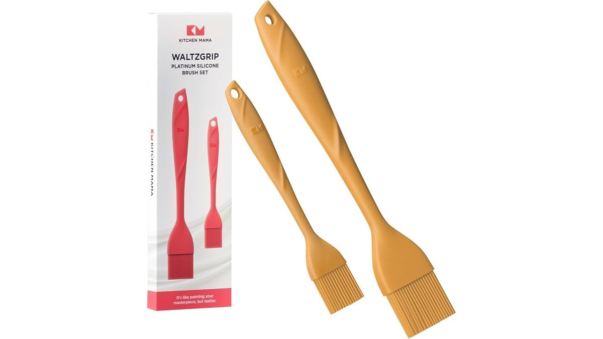 A professional silicone pastry brush set arranged on a marble kitchen countertop.