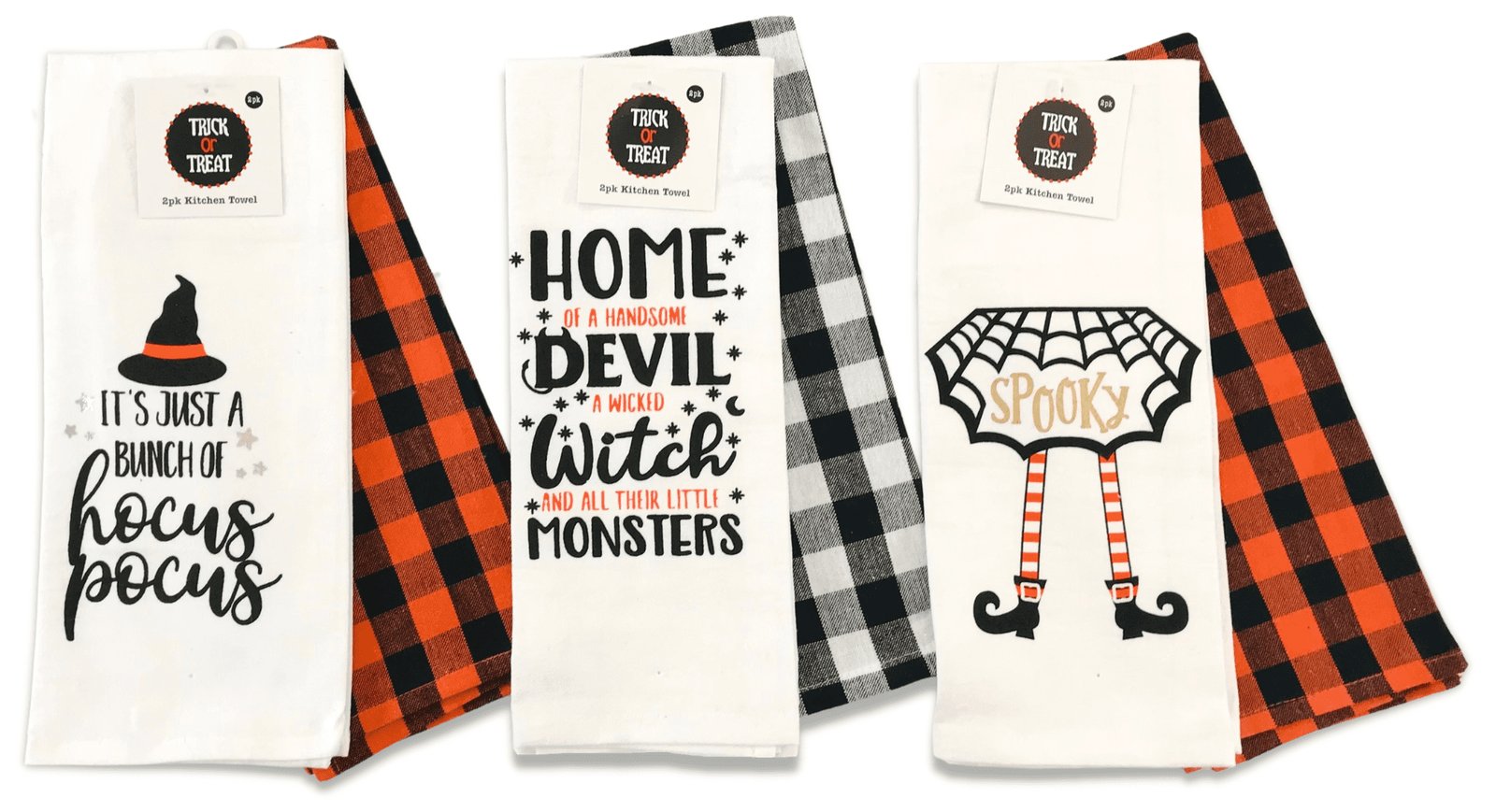 A set of decorative Halloween kitchen towels displayed on a clean marble kitchen counter.