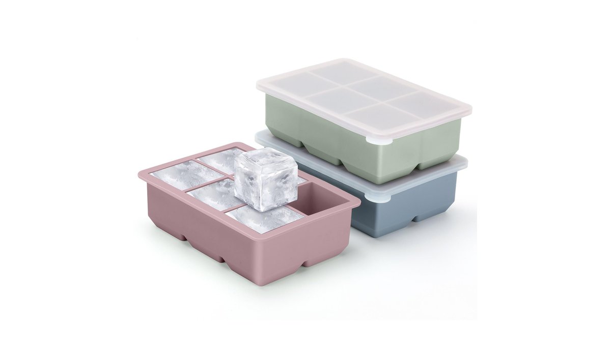 A silicone ice cube tray with a lid sits on a marble countertop.