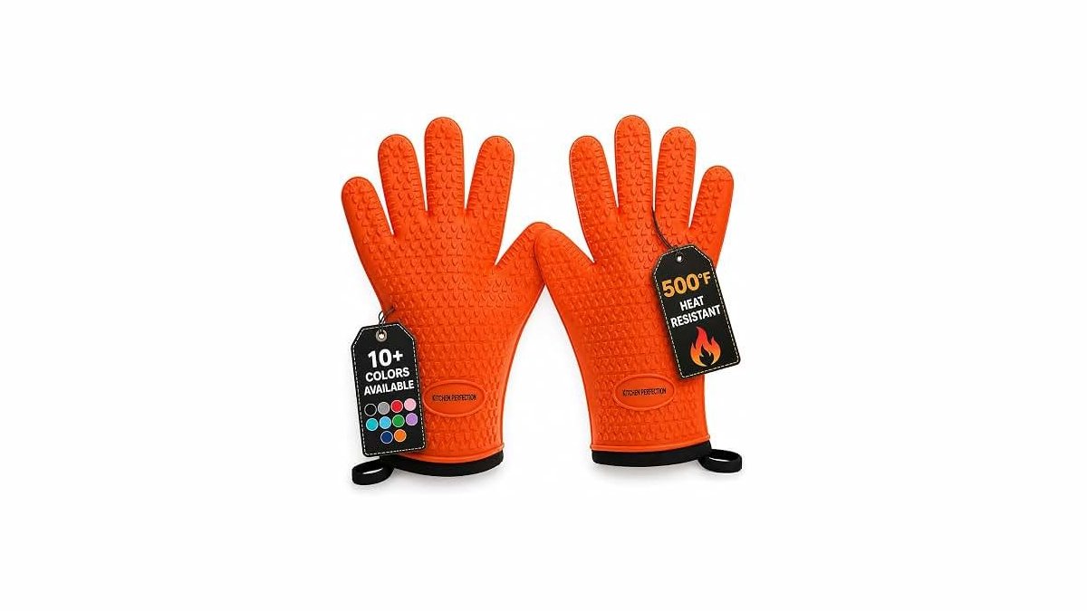 Silicone meat handling gloves for smoker on a stainless steel counter near a grill.