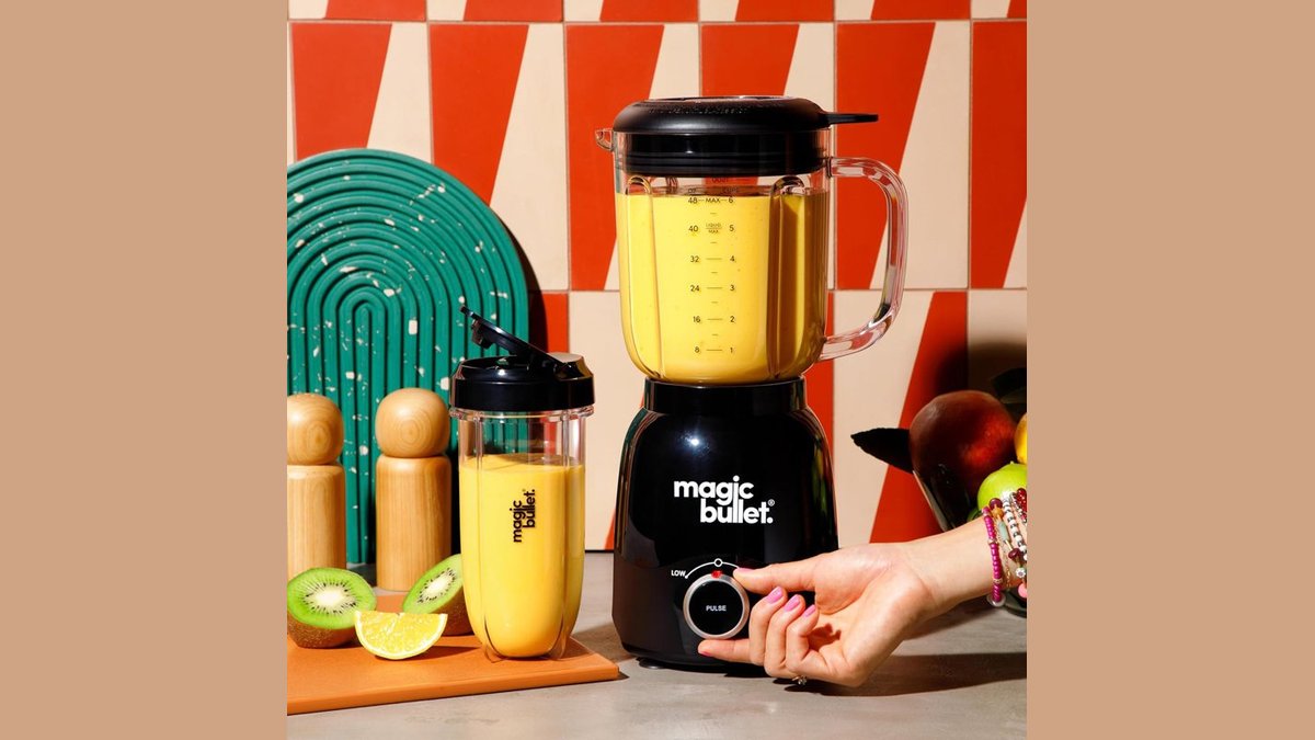 Stainless steel blender on a kitchen counter with fresh fruit for Black Friday deals