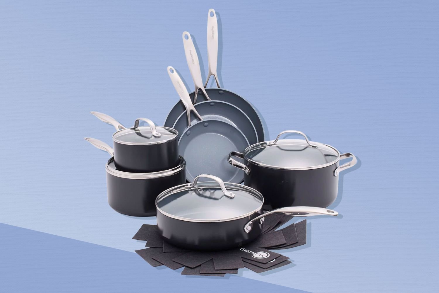 Stainless steel cookware set on a kitchen counter under soft natural light