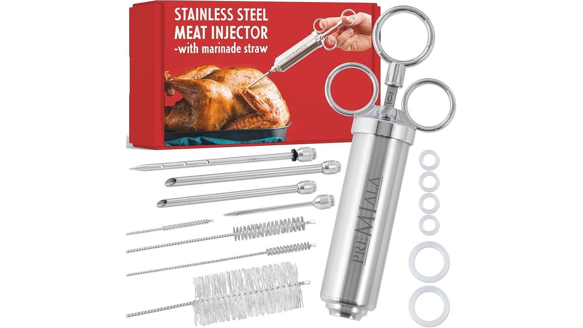 Stainless steel meat injector syringe kit on a marble countertop in natural light.