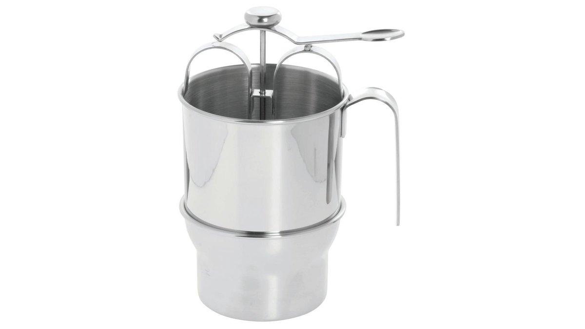A stainless steel pancake batter dispenser carefully pouring batter onto a hot skillet.